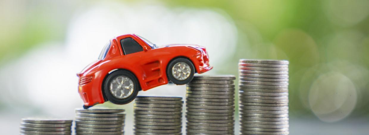 DirectAsia Insurance_red toy car going upwards on stacks of coins